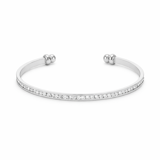 Studio image of a channel set crystal cuff bracelet in silver tone with clean, modern design.