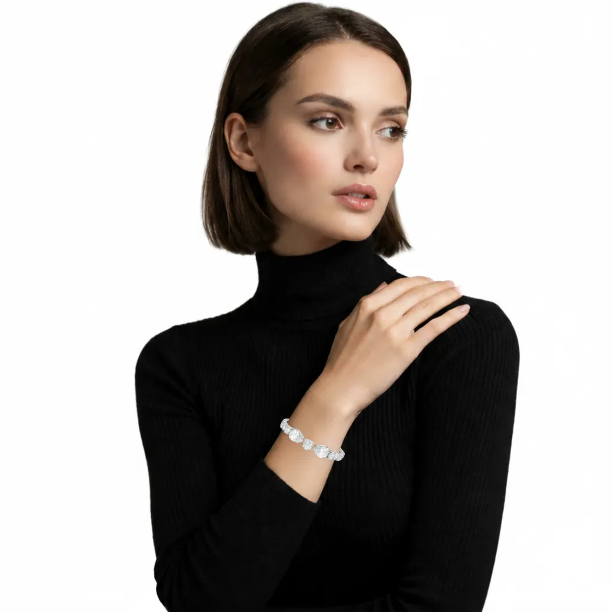 Model view of a silver tone tennis bracelet built from repeating halo links of cushion-cut clear stones, draping over a black knit sleeve for bold sparkle.