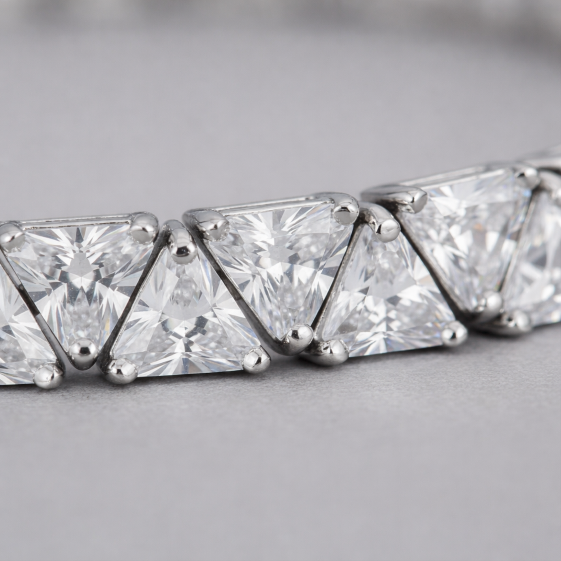 Close up detail of cubic zirconia stones and precise setting in rhodium plated brass.