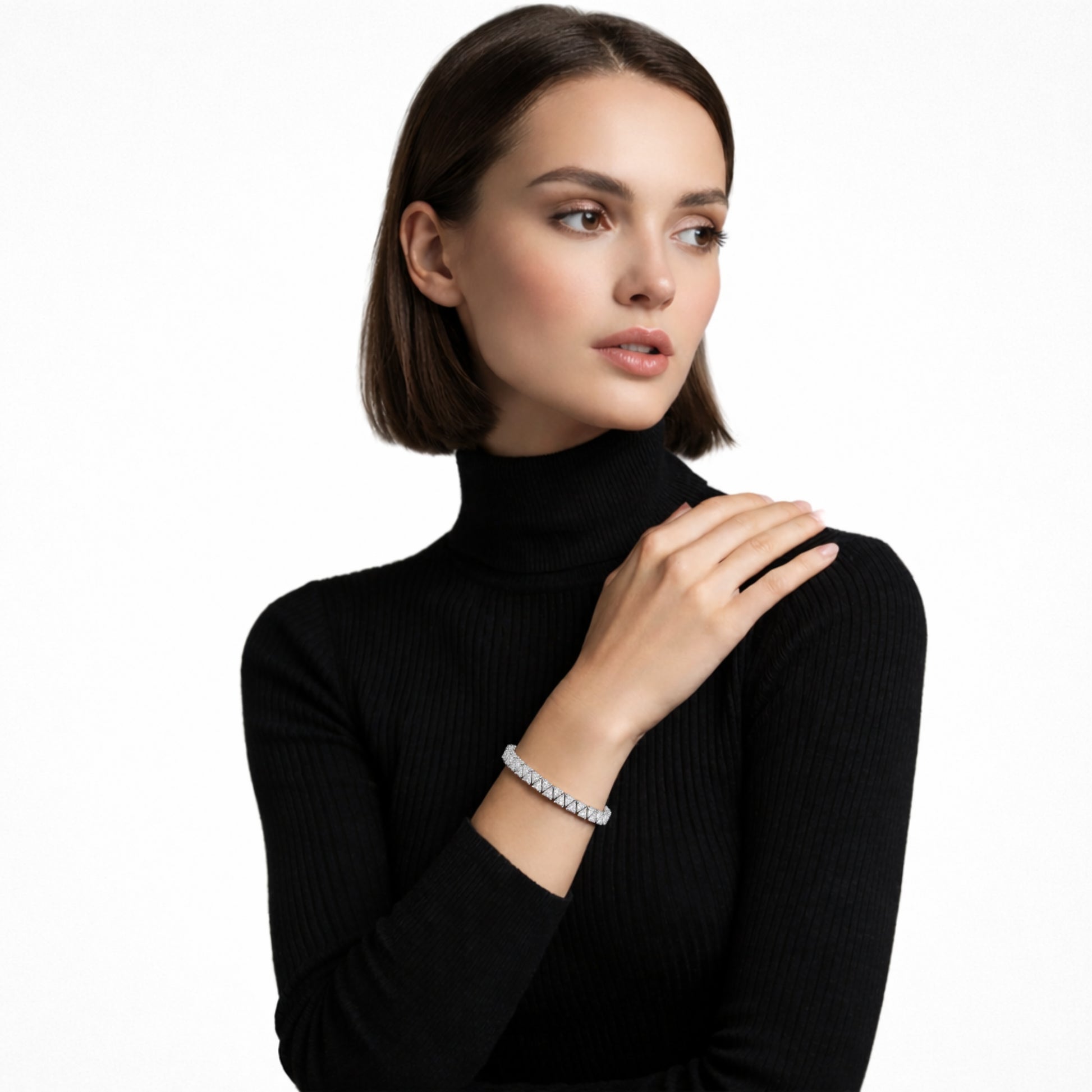 Model view highlights a structured silver tone tennis bracelet built from square cubic zirconia links, stacked over a black ribbed turtleneck for sharp, high-contrast glow.