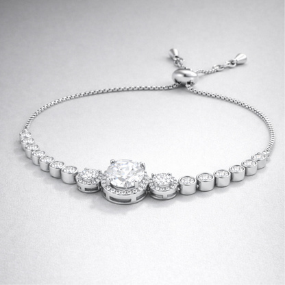 Close up view of the halo style centerpiece with round cut cubic zirconia stones in silver tone setting.