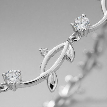 Close up detail of the leaf motif links with cubic zirconia accents and polished silver tone finish.