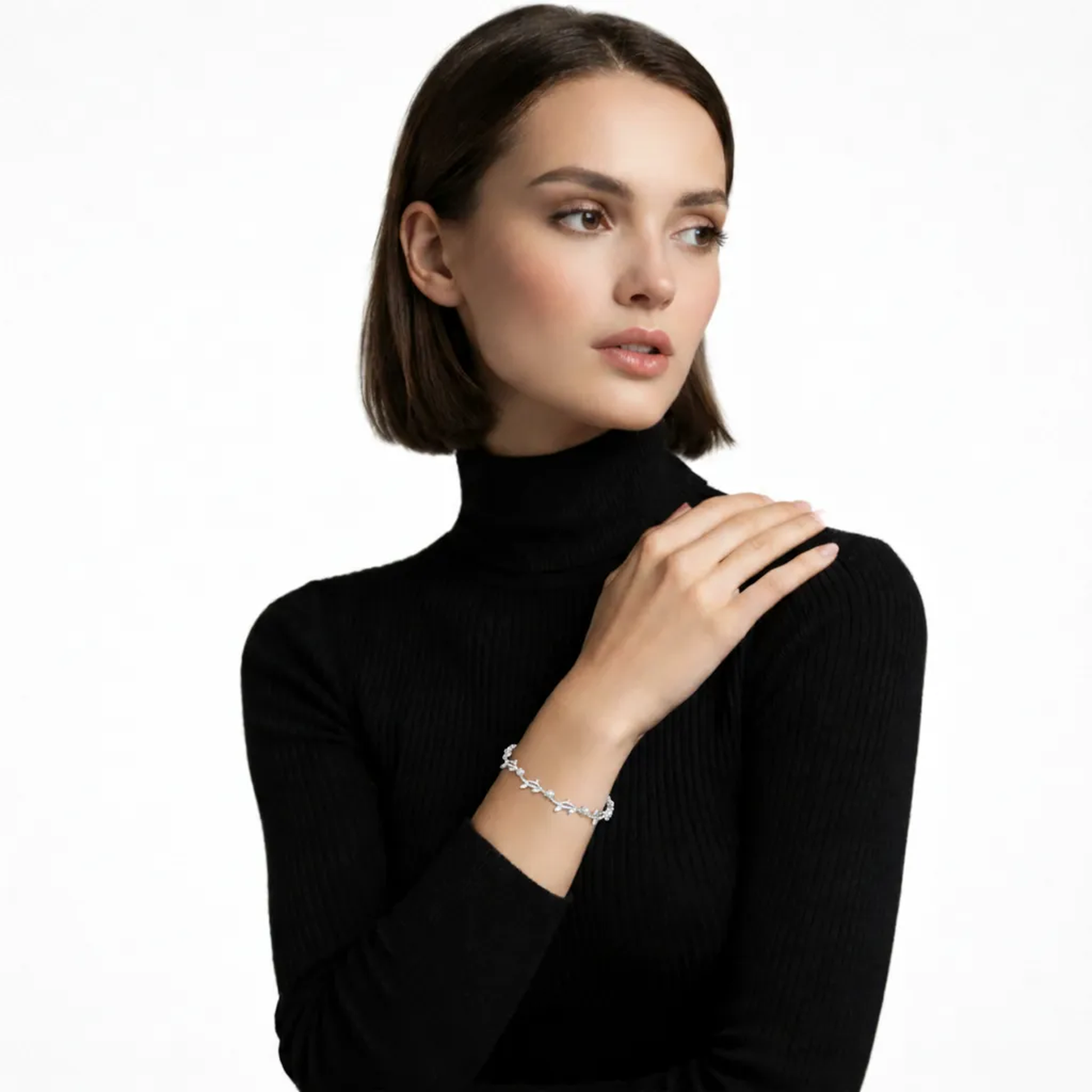 Model view shows a silver tone vine bracelet of marquise cubic zirconia leaves linked with tiny rounds, hugging the wrist above a black ribbed sleeve for airy sparkle.