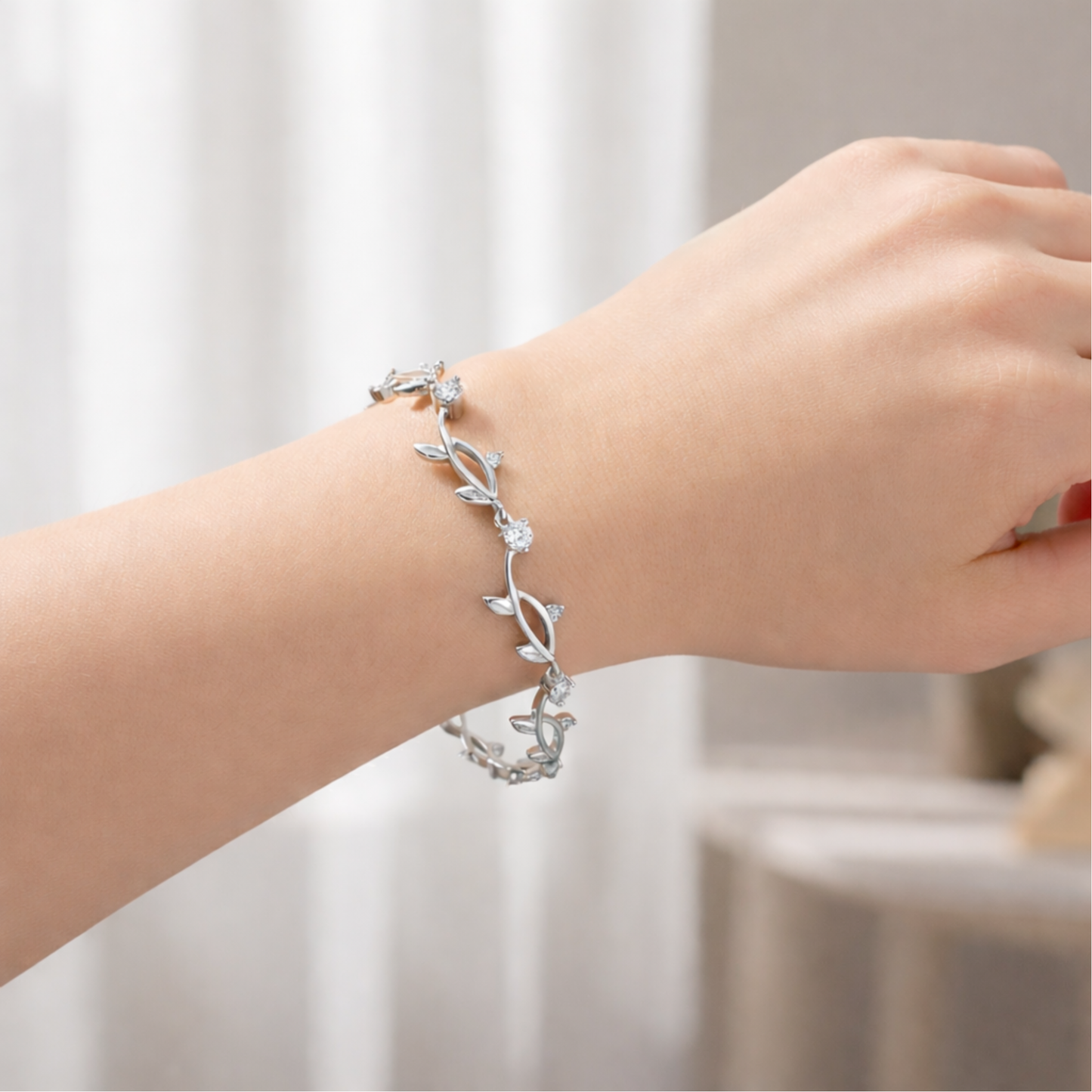 Leaf motif bracelet worn on the wrist, highlighting its lightweight design and refined appearance.